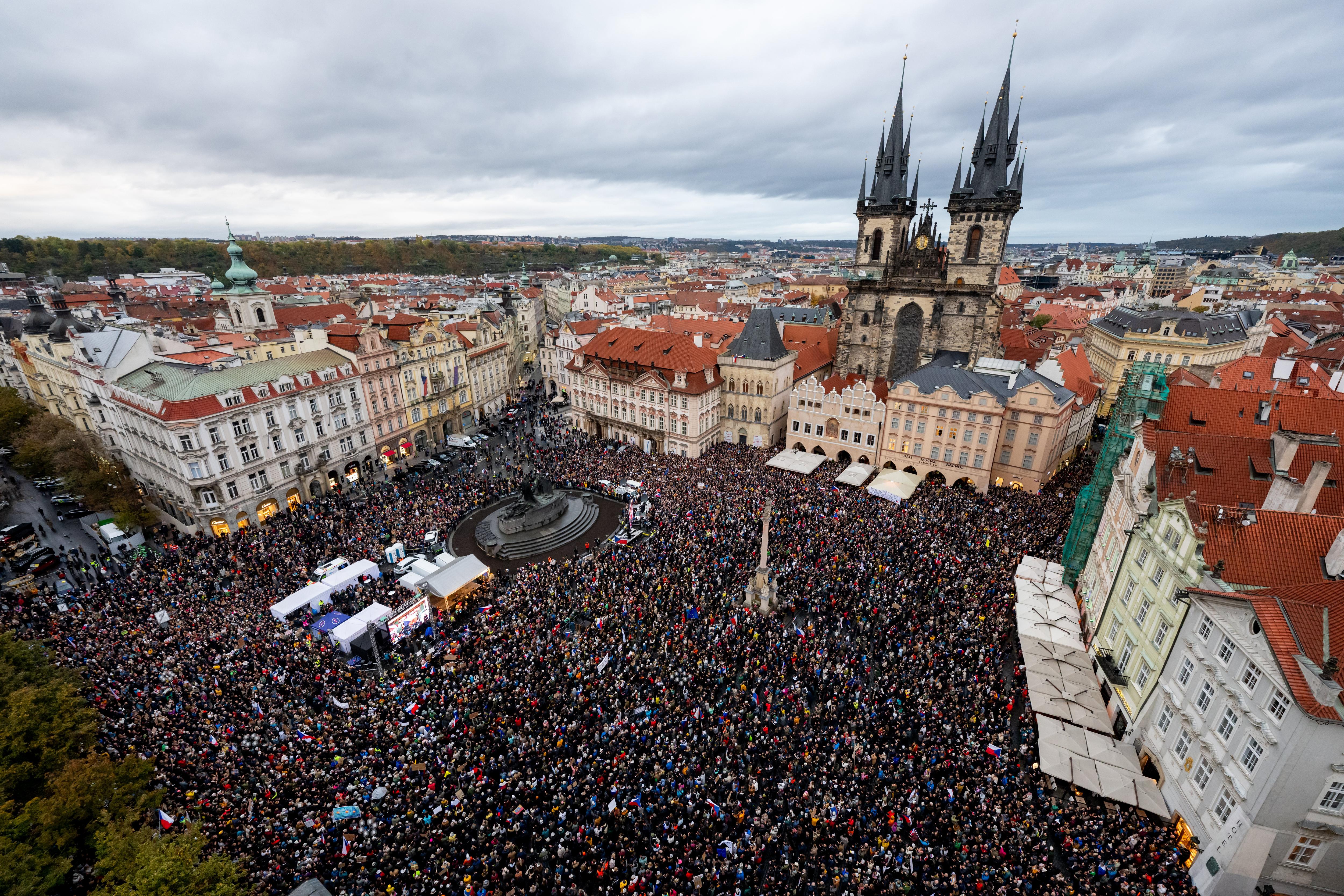 An aerial shot of a large crowd of protesters in the Old Town Square in Prague
