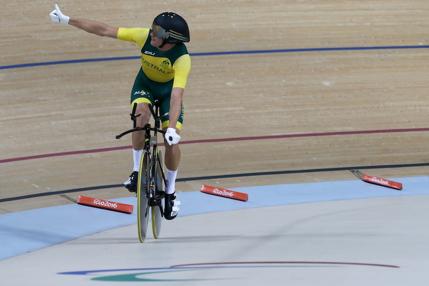 An Australian male cyclist gives the thumbs up after winning gold at the 2016 Paralympics.