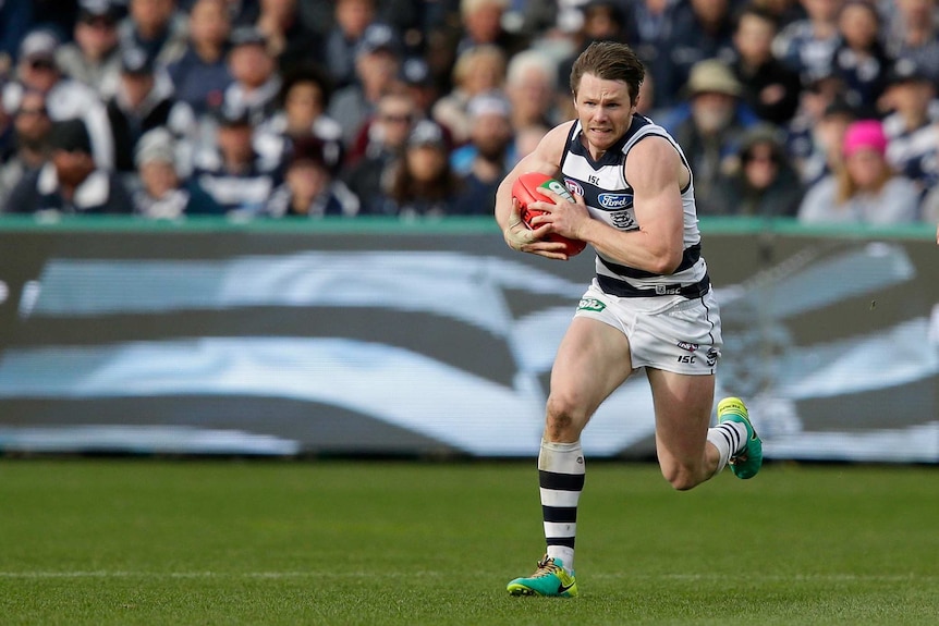 Geelong's Patrick Dangerfield runs with the ball against Melbourne at Kardinia Park in August 2016.