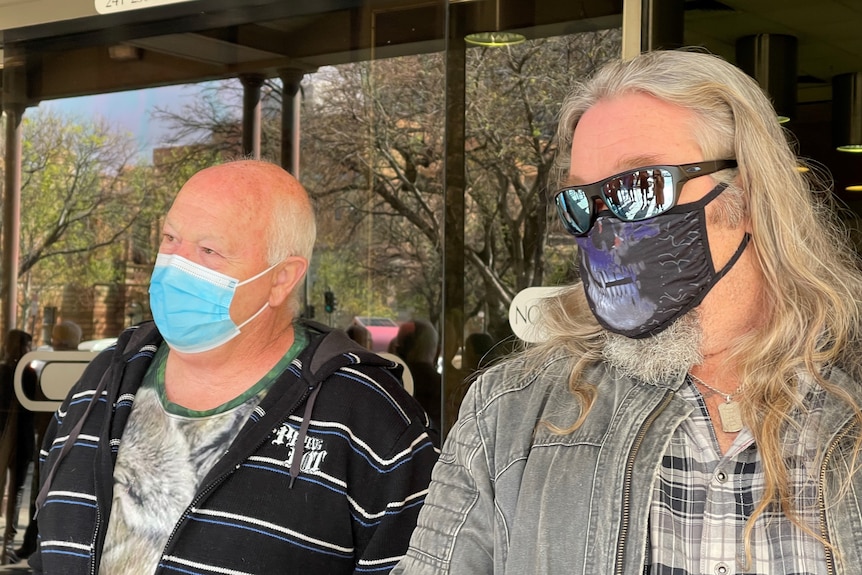 Two men standing outside court