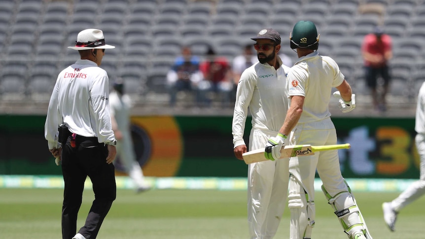 Indian and Australian cricket captains Virat Kohli and Tim Paine bump into each other during a Test match.