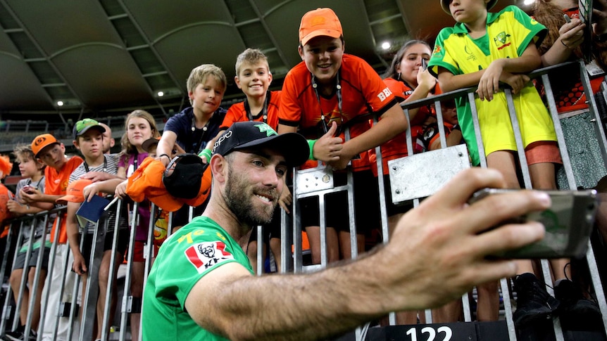 Glenn Maxwell takes a selfie with BBL fans on the boundary after a Melbourne Stars-Perth Scorchers game.