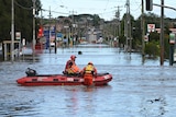 SES boat in a flooded street in Maribyrnong.