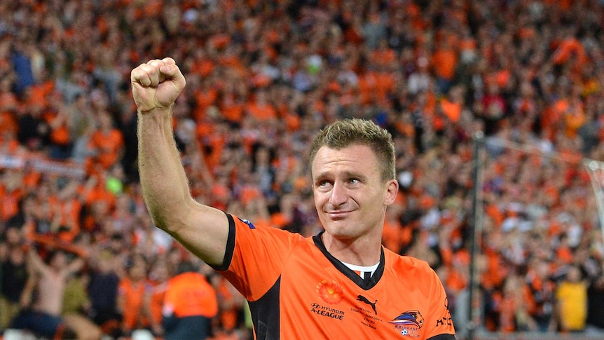 Brisbane's Besart Berisha thanks the fans as he goes up to receive his grand final winner's medal.