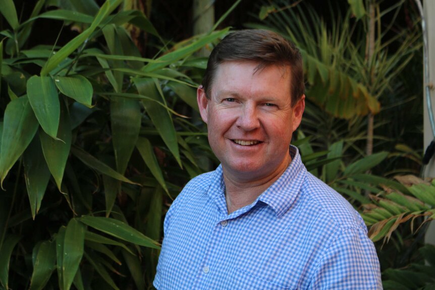 Professor in front of garden bed