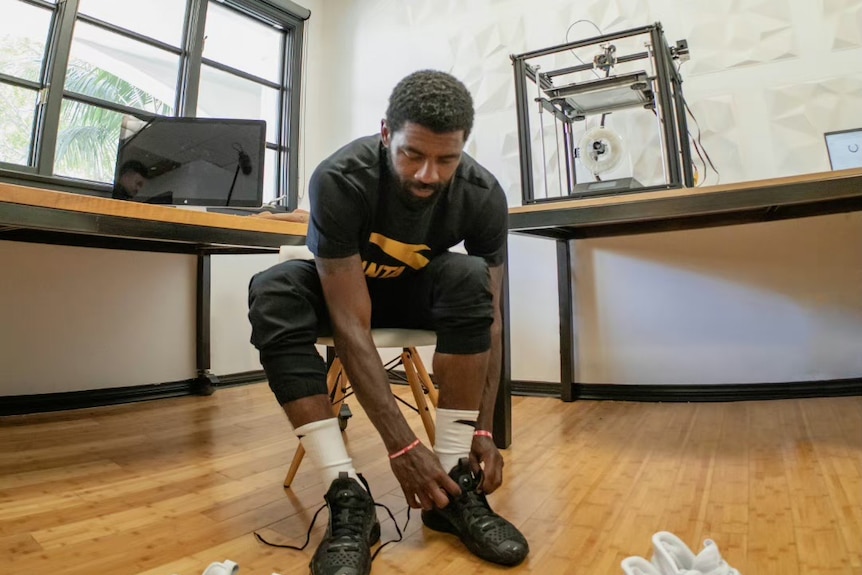 NBA player Kyrie Irving trys on Anta sneakers.