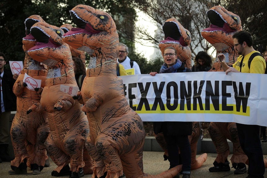 Environmental activists rally outside the committee hearing