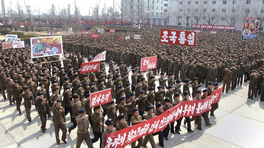 North Koreans attend a rally held to gather their willingness for a victory in a possible war against the US and South Korea.