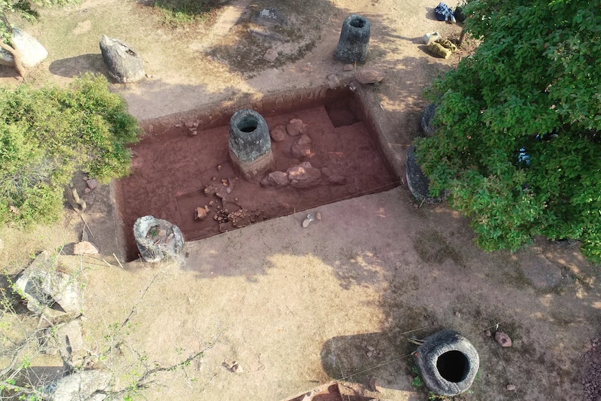 An aerial shot of an archaeological site with giant stone jars