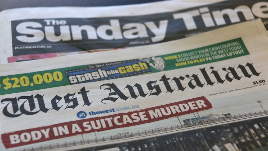 Copies of The West Australian and The Sunday Times lie on a table.