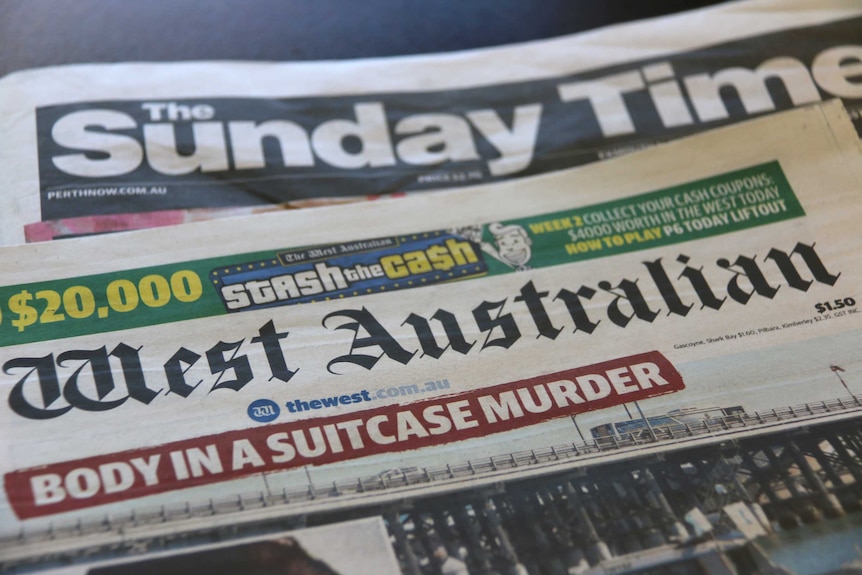Copies of The West Australian and The Sunday Times lie on a table.