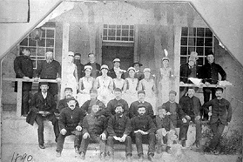 Old photo of staff assembled for group photo.