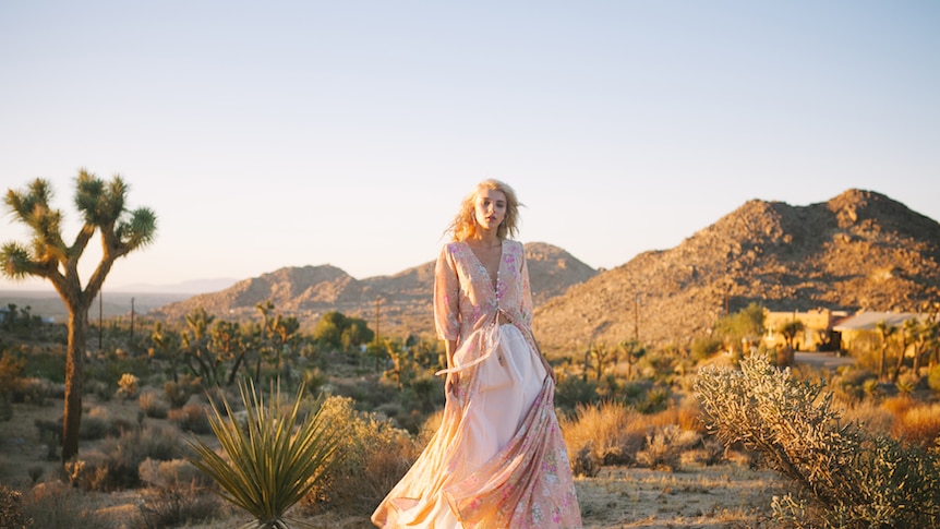 Model in the desert wearing floral dress