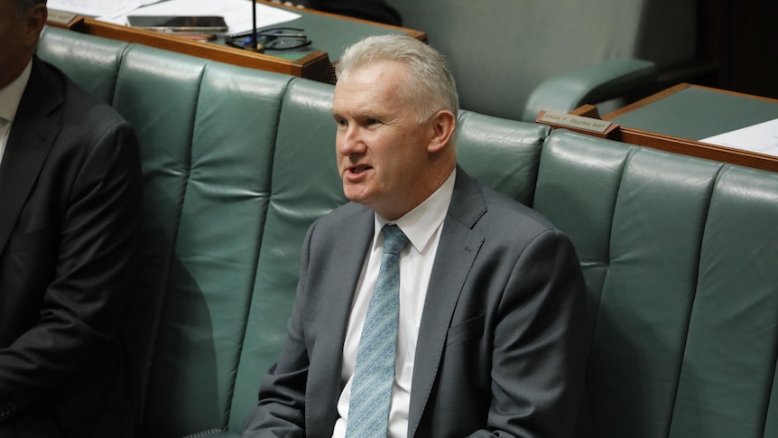 Tony Burke sitting on the front bench in the House of Representatives. 