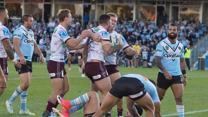 Manly's Curtis Sironen celebrates scoring a try against the Cronulla Sharks