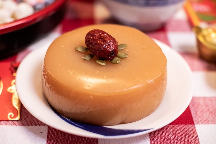 Lunar New Year year cake on a plate on a festive table setting.