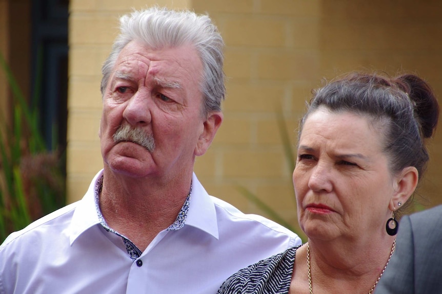 Ray and Margaret Dodd look solemn at Labor's press conference on "no body, no parole" laws.