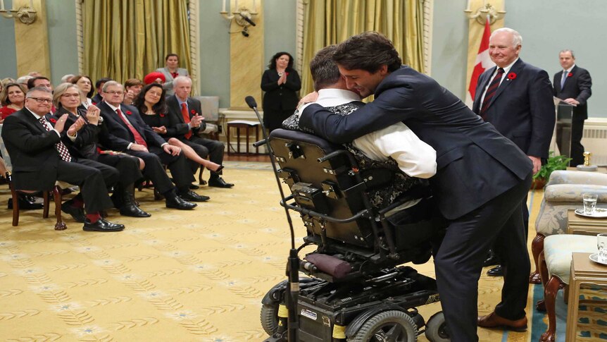 Justin Trudeau hugs new veterans affairs and associate minister for defence Kent Hehr.