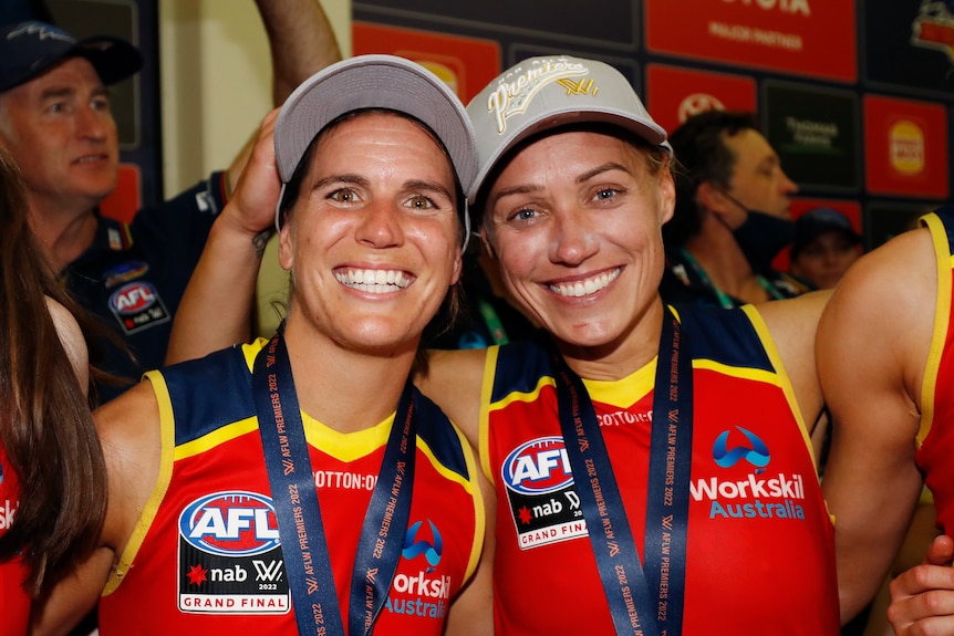 Chelsea Randall and Erin Phillips smile and stand arm-in-arm