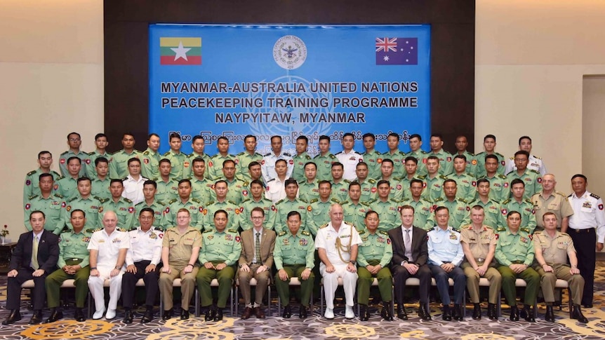 Australian and Myanmar officials pose for an official photograph in Naypyidaw, Myanmar.