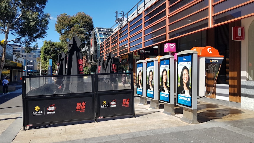 Billboards sit on Telstra phone booths near Box Hill plaza Melbourne.