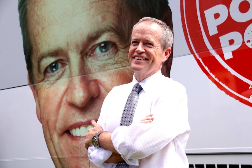 Bill Shorten in front of Labor's election bus which features his face