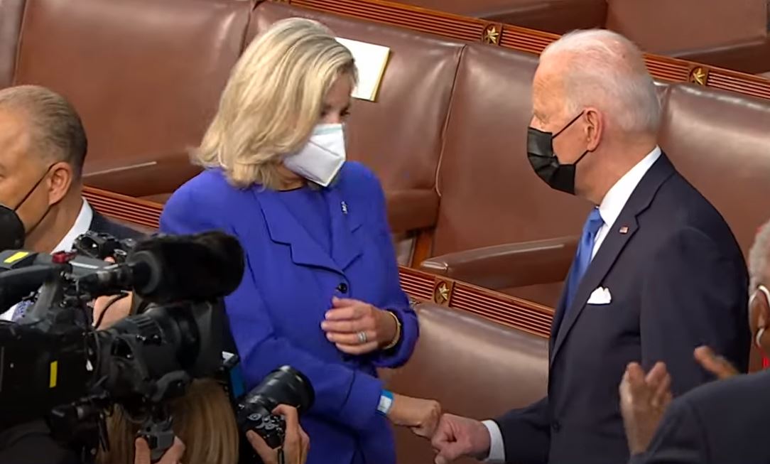 Representative Liz Cheney fist bumps US President Joe Biden 