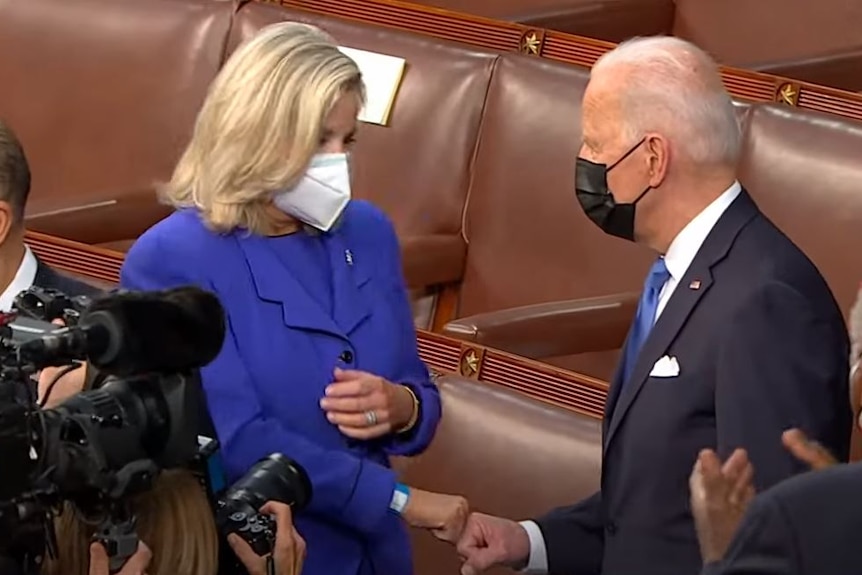 Representative Liz Cheney fist bumps US President Joe Biden 