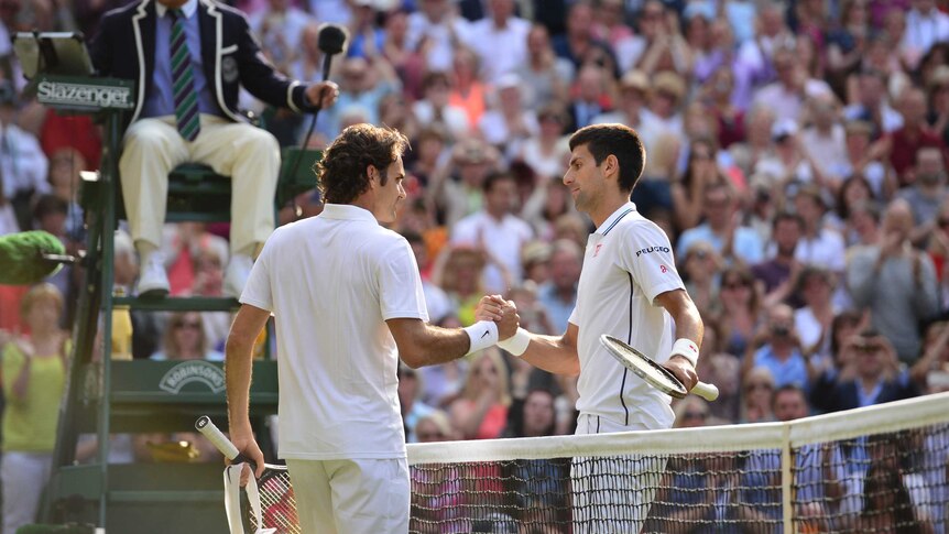 Serbia's Novak Djokovic (R) shakes hands with Swiss Roger Federer after winning Wimbledon in 2014.