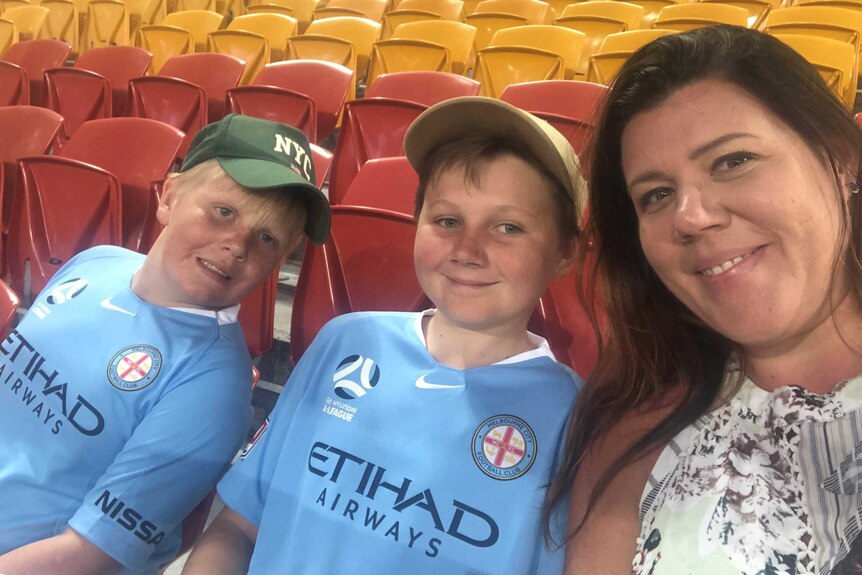 Hope Rust with her sons in an empty stadium before a Melbourne City soccer game before the pandemic.