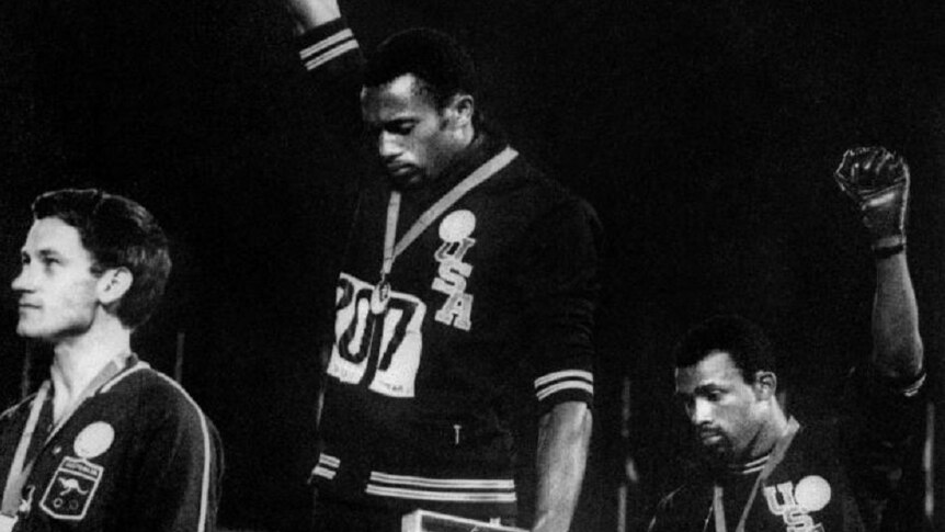 Americans Tommie Smith and John Carlos raise their fists