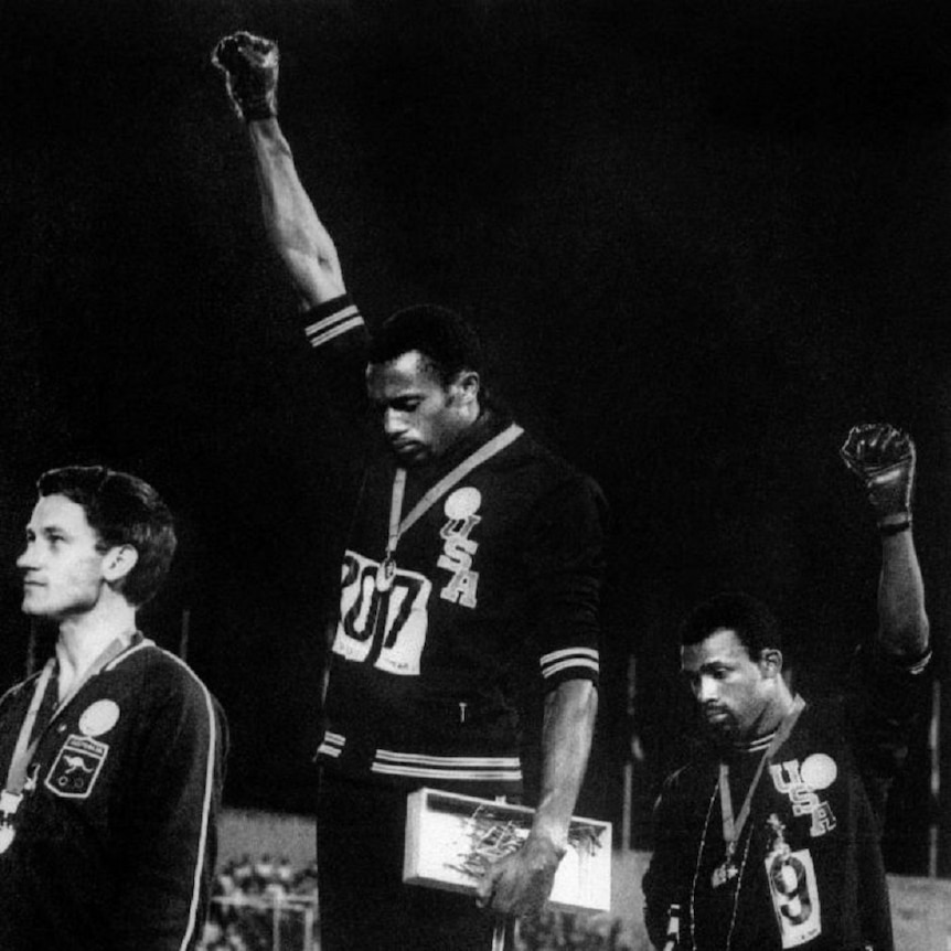 Americans Tommie Smith and John Carlos raise their fists