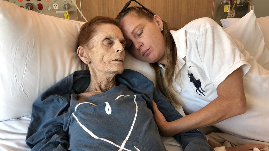 Cancer patient Josephine Collins with her daughter Amy Knowles on a cuddle bed in the Robina Hospital's palliative care ward.