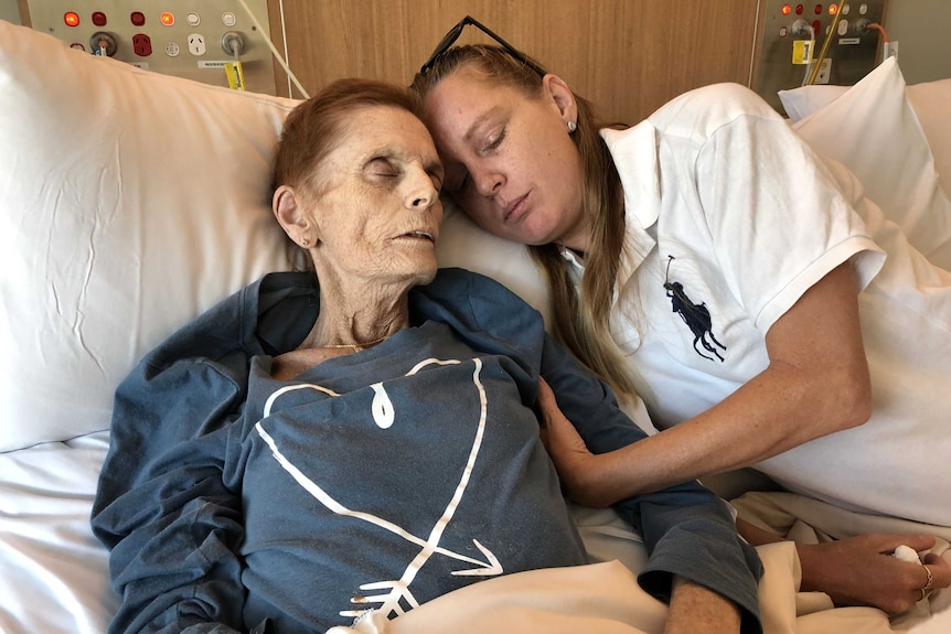 Cancer patient Josephine Collins with her daughter Amy Knowles on a cuddle bed in the Robina Hospital's palliative care ward.