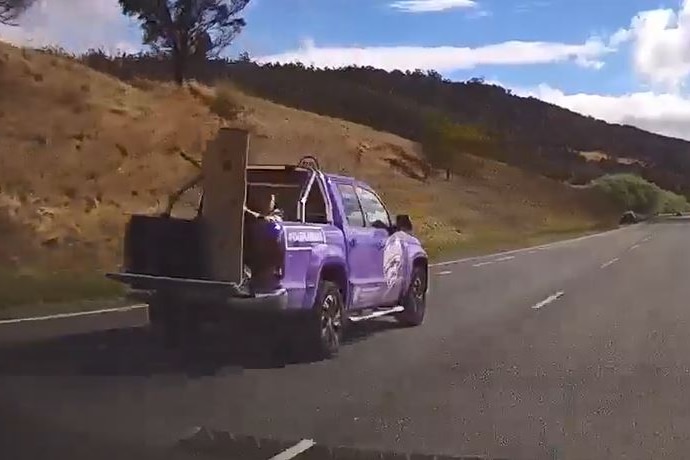 Purple ute travelling on major Tasmanian highway as seen by a dash cam in pursuing car.