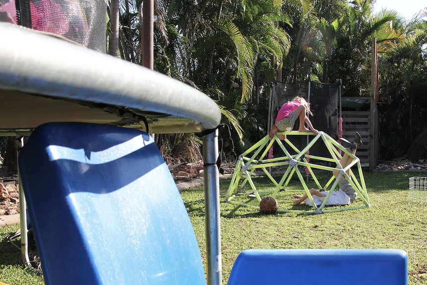 two children playing in a backyard