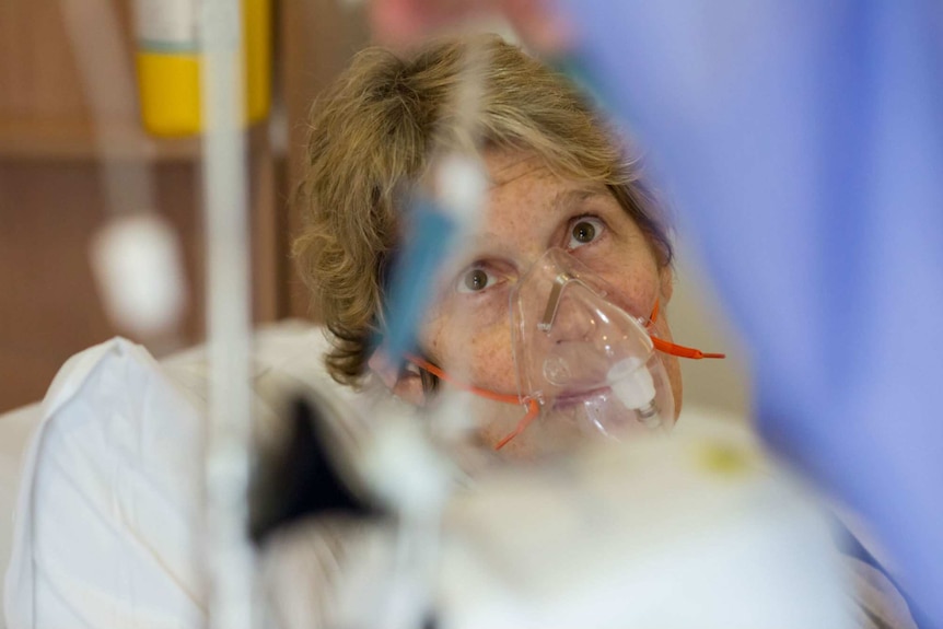 Sue Jensen in an oxygen mask during treatment