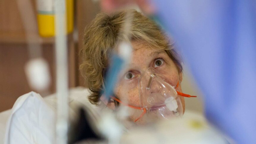 Sue Jensen in an oxygen mask during treatment