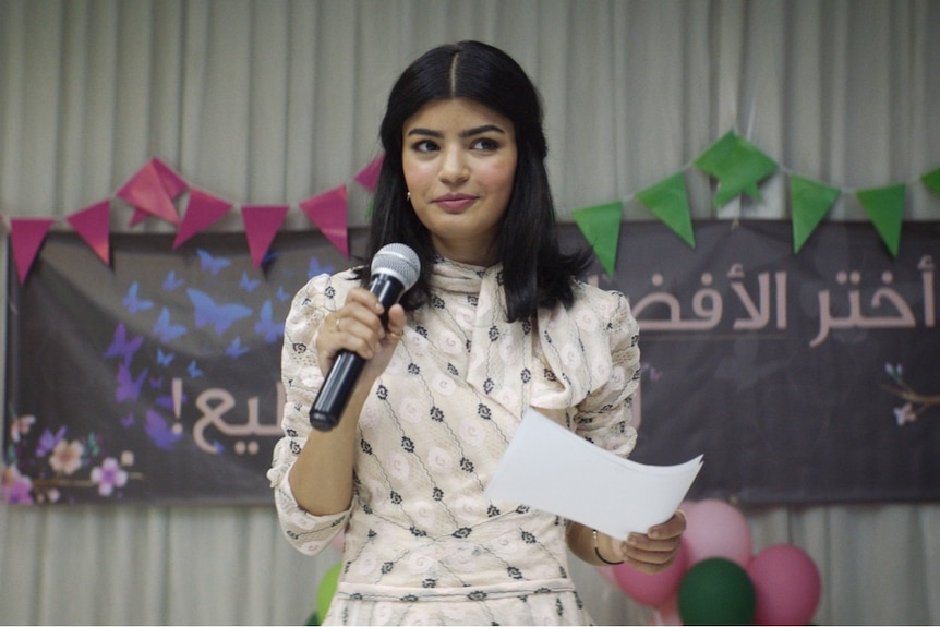 Film still of Mila Al Zahrani as Maryam public speaking in The Perfect Candidate