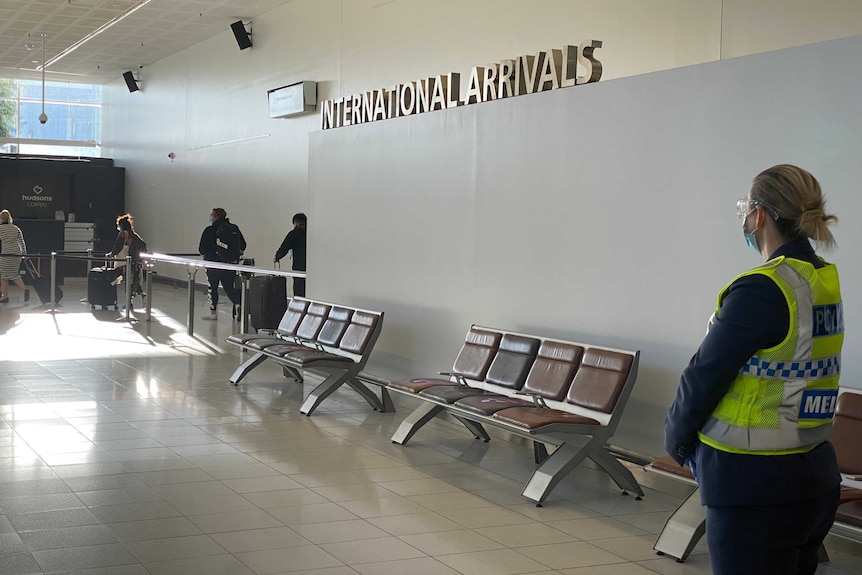 Masked police and passengers at Adelaide Airport.