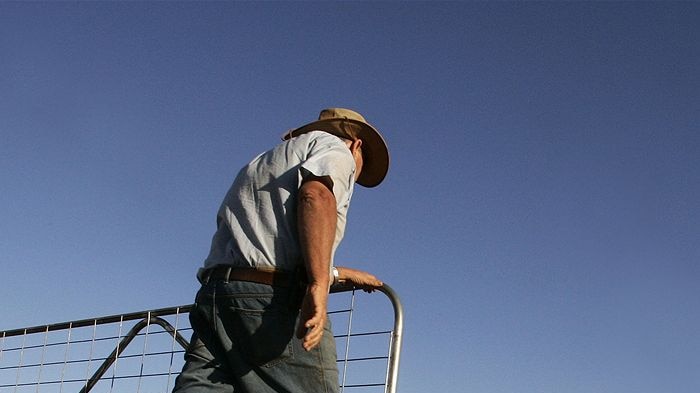 Farmer John Ridley closes a gate on his farm near the town of West Wyalong, 2007