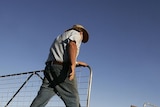 Farmer John Ridley closes a gate on his farm near the town of West Wyalong, 2007