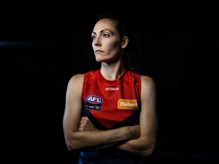 Meg Downie wears a red and blue AFL singlet