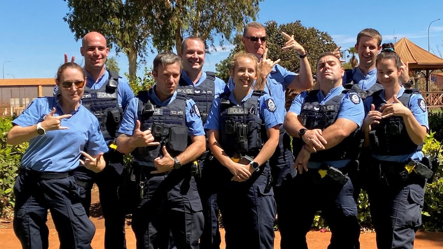 Officers from Port Hedland police pulling funny faces