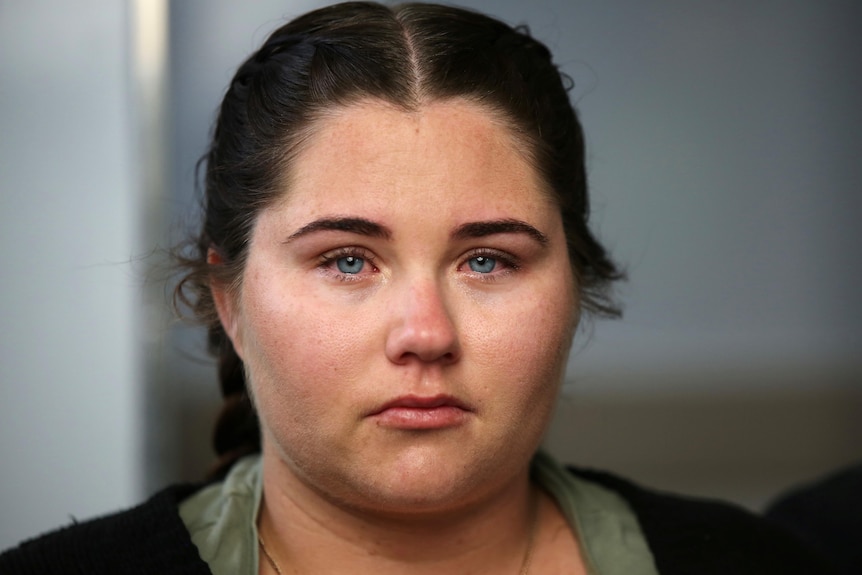 A close up of a mother with tears in her eyes