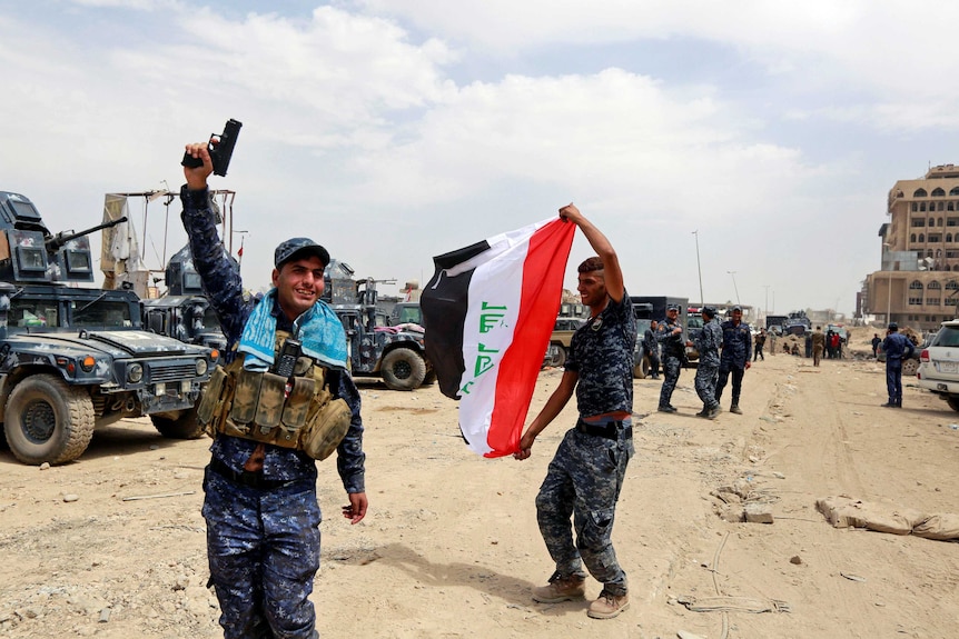 Iraqi Federal Police celebrate in the Old City of Mosul.
