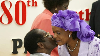 Zimbabwe President Robert Mugabe is kissed by his wife Grace at his 80th birthday party in his home area of Zvimba.