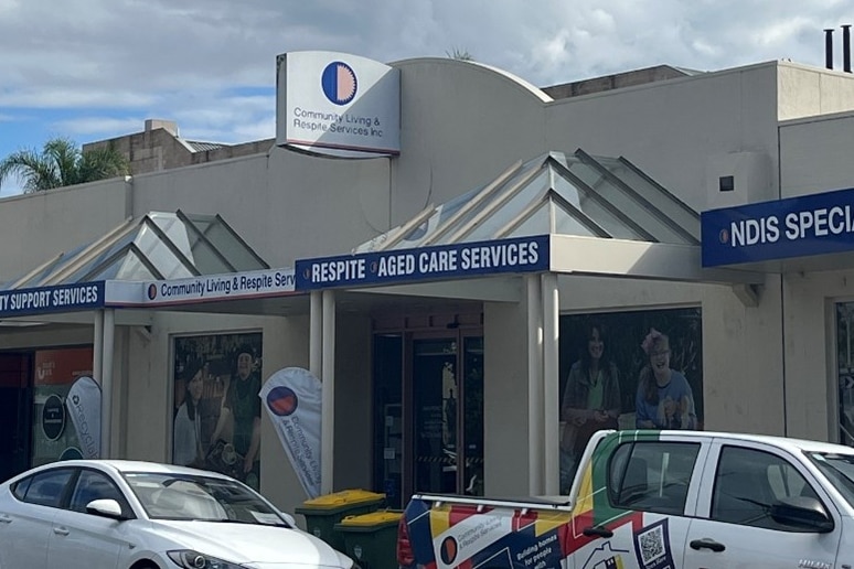 A photo of the exterior of a building, showing signs 'ndis specialist'