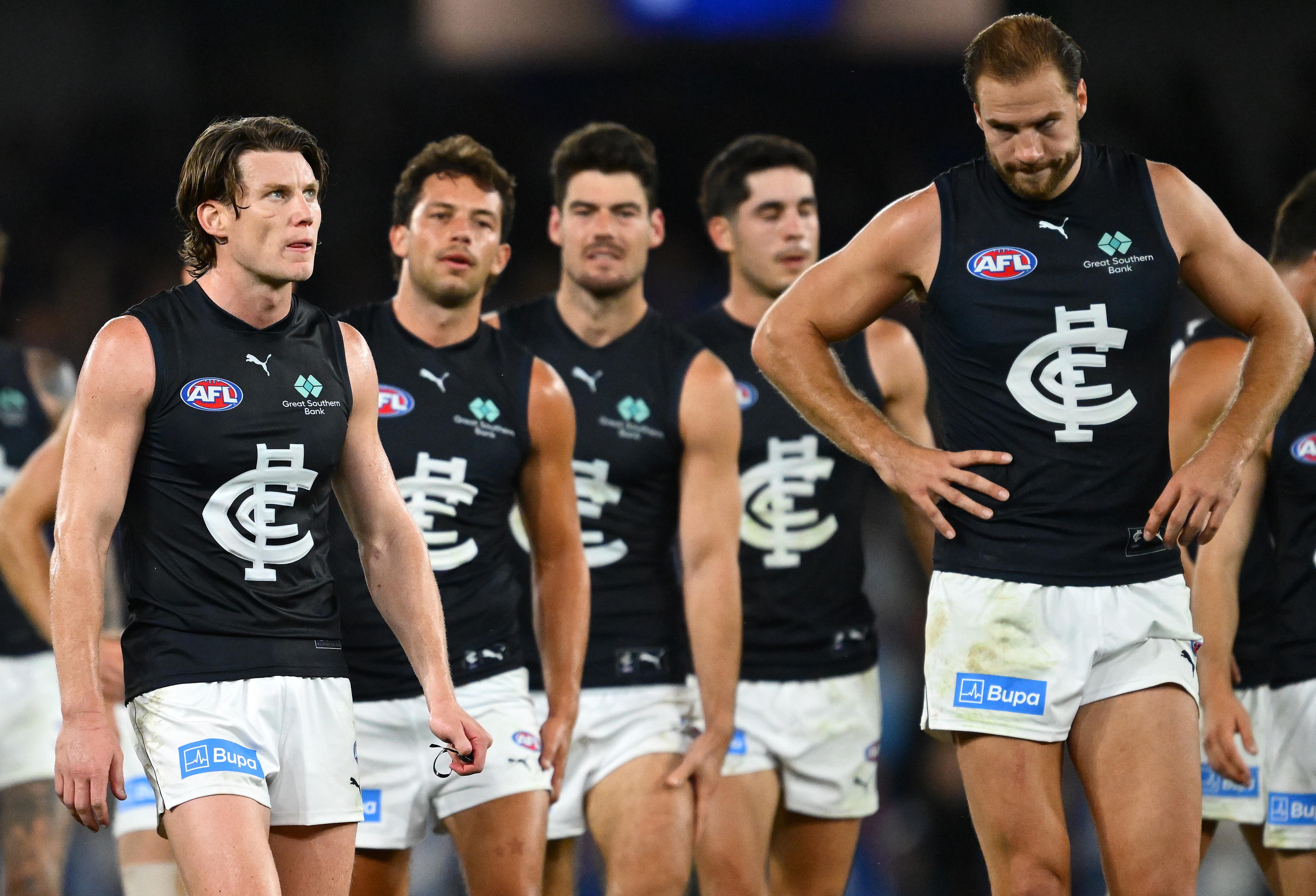 Blues AFL players look dejected as they walk off the field following their loss to the Kangaroos.