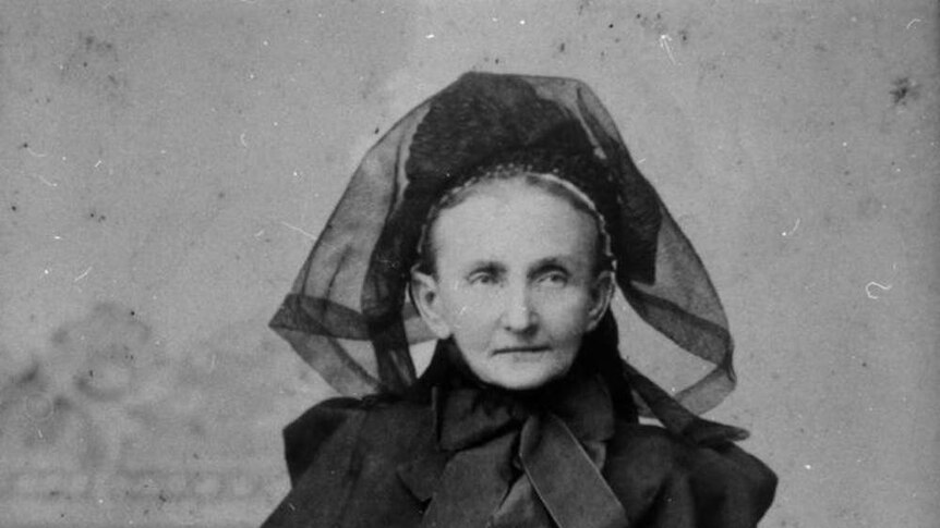 Historical photo of a woman in a mourning gown.
